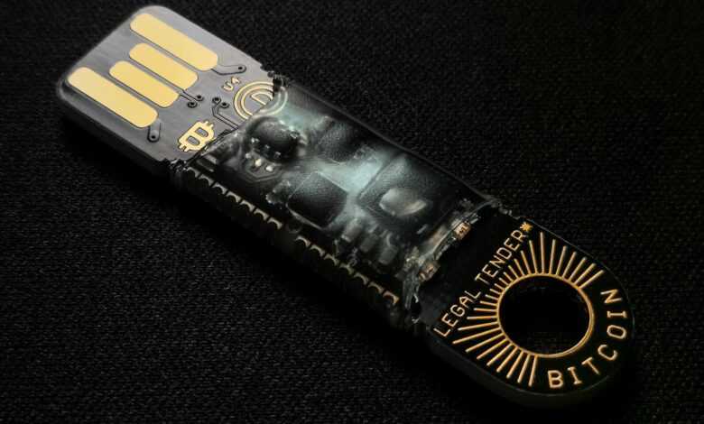A detailed close-up of a Bitcoin-themed USB device on a black background.