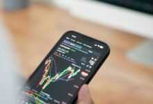 a person holding a cell phone in their hand