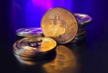 a pile of bitcoins sitting on top of a table