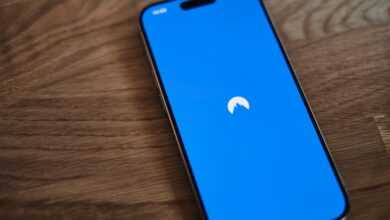 A blue phone sitting on top of a wooden table