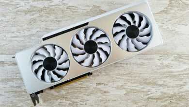 a white and black fan sitting on top of a wooden table