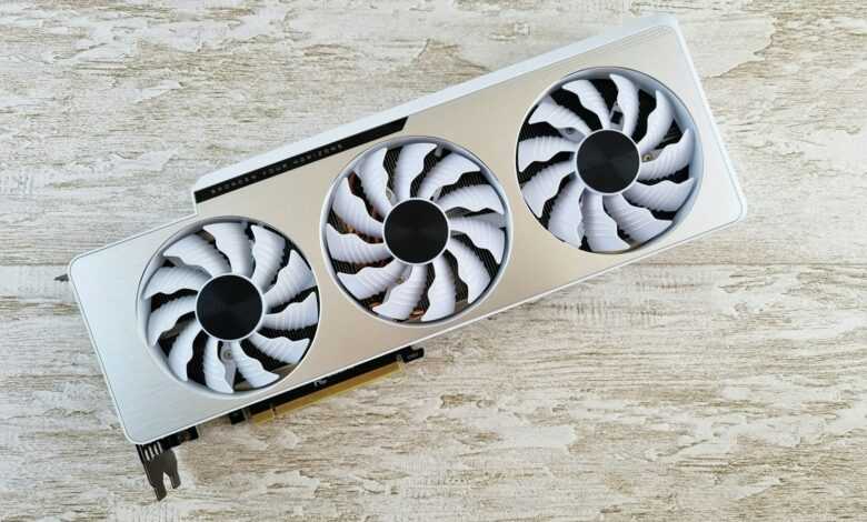 a white and black fan sitting on top of a wooden table