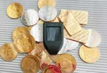 a cell phone sitting on top of a pile of coins