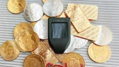 a cell phone sitting on top of a pile of coins