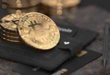 silver round coin on black leather case