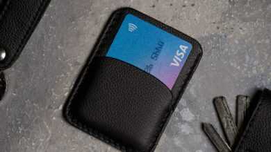 a black wallet with a credit card and keys