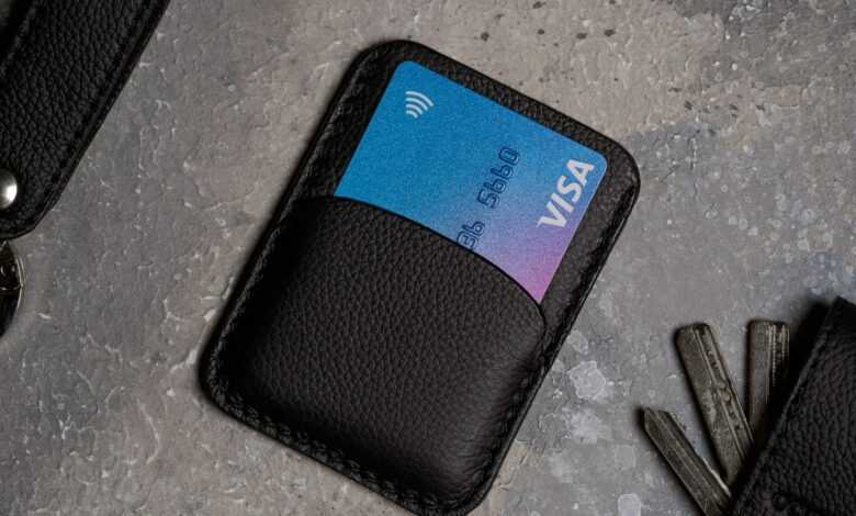a black wallet with a credit card and keys