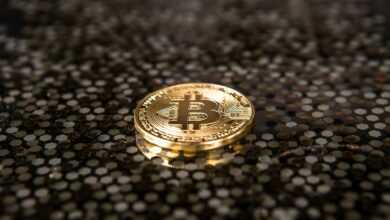 gold-colored Bitcoin coin on ground