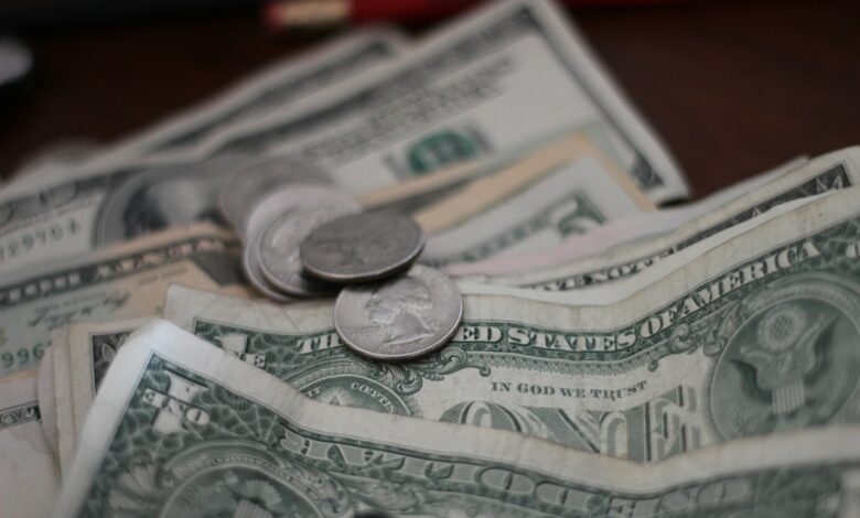 photo of dollar coins and banknotes