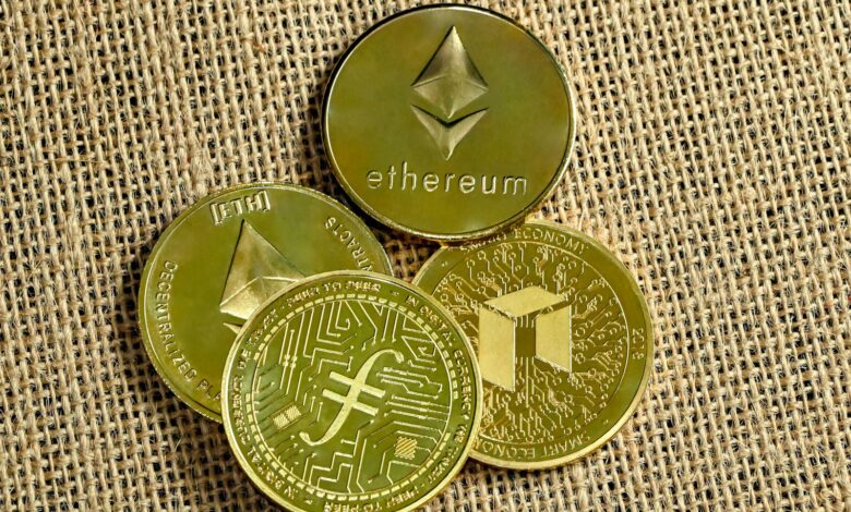 three gold coins with a bitcoin on top of them
